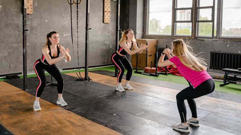 Woman doing squats in gym